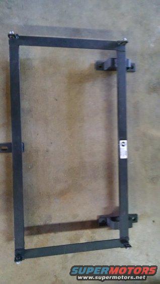 metal frame with mounting brackets, possibly for a seat or battery