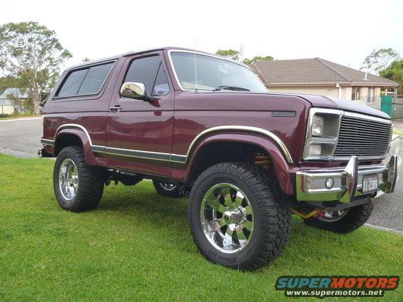 Maroon 1985 Ford Bronco with chrome trim and aftermarket wheels
