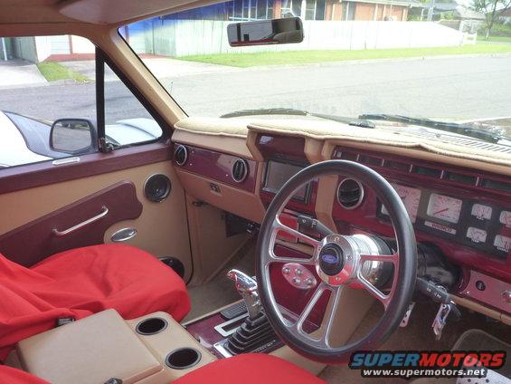 1985 Ford Bronco interior showing dashboard, steering wheel, and seats. Gauges are visible