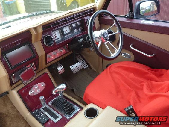 Custom interior with aftermarket steering wheel, gauges, and shifter