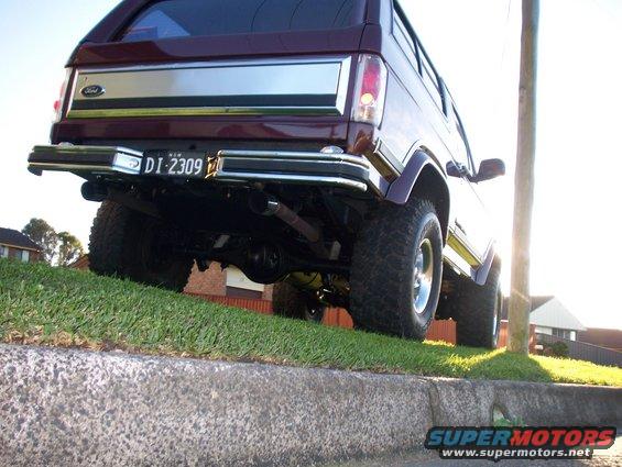 1985 Ford Bronco rear view, parked on a grassy incline
