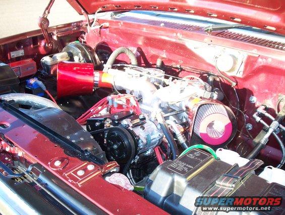 Engine bay with red air filter and custom intake