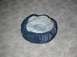 1979 Ford Bronco II - A tire cover with a clear plastic window is shown resting on a concrete surface.
