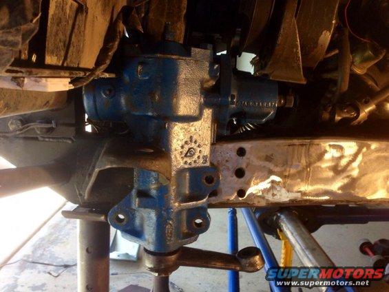 Blue steering box assembly with linkage attached to a metal frame