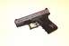 1990 Max II - A Glock 19 Gen 4 pistol is shown with a butterfly decal on its textured grip.