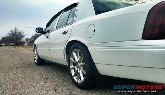 White 2000 Mercury Grand Marquis sedan, side view, showing alloy wheels and tinted taillights