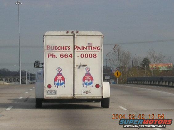 White trailer with red lettering for Bueche's Painting, rear view