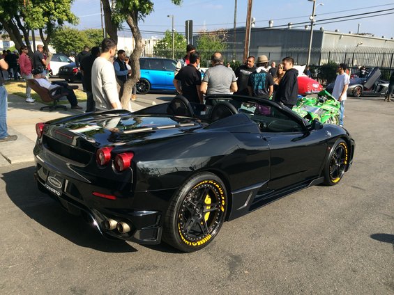 Black convertible sports car with yellow tire lettering and brake calipers