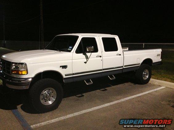 1997 Ford F-350 crew cab pickup truck parked at night