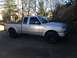 2010 Ford Ranger - A silver Ford Ranger pickup truck is parked in a driveway with trees and a wooden deck in the background.