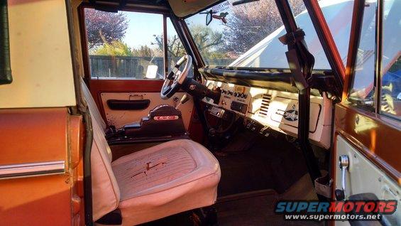 Interior view of a 1978 Ford Bronco, showing the driver's seat, dashboard, and center console