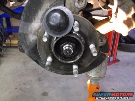 Wheel hub assembly with brake rotor and lug studs. Supermotors.net logo visible