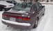 1996 Subaru Legacy - A 1996 Subaru Legacy sedan is parked in the snow, with another vehicle visible to its left.