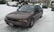 1996 Subaru Legacy - A 1996 Subaru Legacy sedan sits in a snowy driveway with other vehicles nearby.
