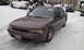 1996 Subaru Legacy - A Subaru sedan sits in a snowy driveway with other vehicles visible in the background.