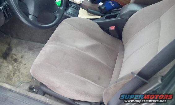 Car interior showing passenger seat, dashboard, and steering wheel