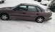1996 Subaru Legacy - A brown sedan sits in a snowy environment, partially covered by snow.