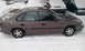 1996 Subaru Legacy - A 1996 Subaru Legacy sedan sits parked in the snow, with other vehicles visible in the background.