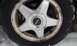 1996 Subaru Legacy - Subaru wheel and tire shown in detail, with visible brake rotor behind the wheel.