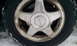 1996 Subaru Legacy - A close-up view of a Subaru wheel and tire, showing some dirt and snow accumulation.