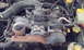 1996 Subaru Legacy - Close-up view of a vehicle's engine compartment, showing the alternator, intake manifold, and other engine parts.