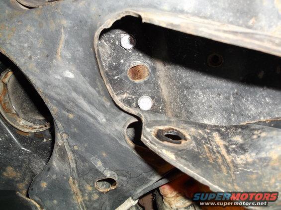 Close-up of rusty metal frame parts with bolts