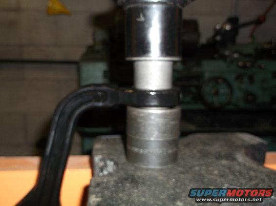 Socket wrench on bolt with "SUPERMOTORS" watermark