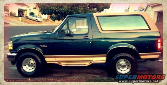 1995 Ford Bronco side view, dark green with tan top