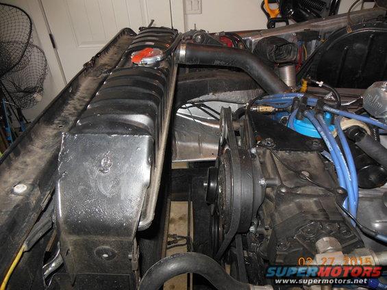 Radiator and engine components of a 1979 Ford F-150, showing belts, hoses, and distributor cap