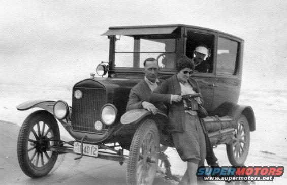 1909 Ford Model T with two people posing by the beach, license plate 4012