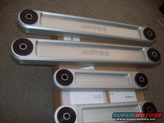 Four silver control arms with black bushings and 'METCO' branding