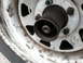1981 Ford Bronco - This image shows a close-up view of a vehicle's front hub assembly, including the wheel and tire.