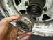 1981 Ford Bronco - Close-up of a manual locking hub being held, with the wheel and hub assembly visible.