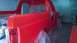 1983 Ford Bronco - Ford Bronco undergoing a fresh coat of red paint in a spray booth.