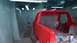 1983 Ford Bronco - A red pickup truck is being prepped for painting inside a makeshift booth with plastic sheeting and lights.