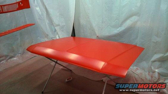 Orange hood on a stand in a spray booth