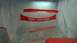 1983 Ford Bronco - Car parts painted red and hanging to dry in a spray booth.