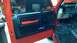 1983 Ford Bronco - Interior view of a red truck, focusing on the door panel and the dashboard with visible wiring.