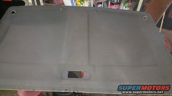 Gray vehicle headliner with a rectangular cutout and two D-ring mounting points