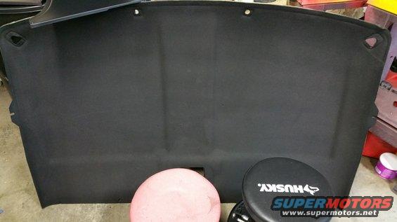 Black headliner with mounting holes, sitting on a pink stool and a Husky stool