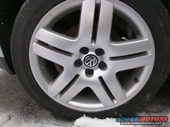 Volkswagen wheel with five spokes and a central logo