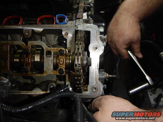 mechanic working on engine timing chain