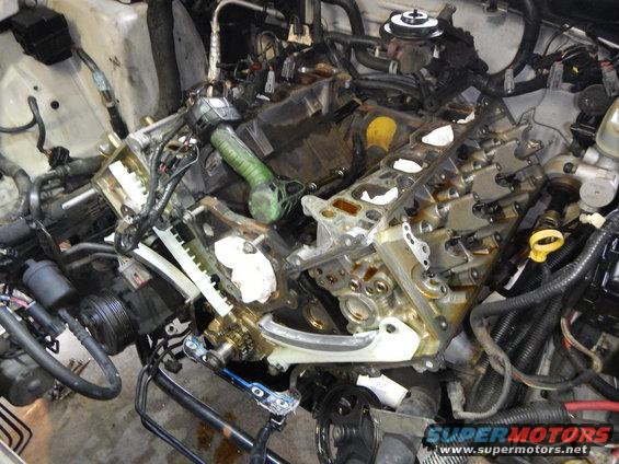 Engine with timing chain exposed, undergoing repair
