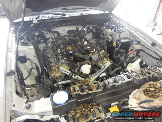 2002 Ford Mustang engine disassembled with parts laid out on a cloth