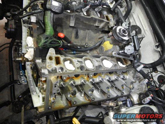 Engine with timing chain exposed, tools present