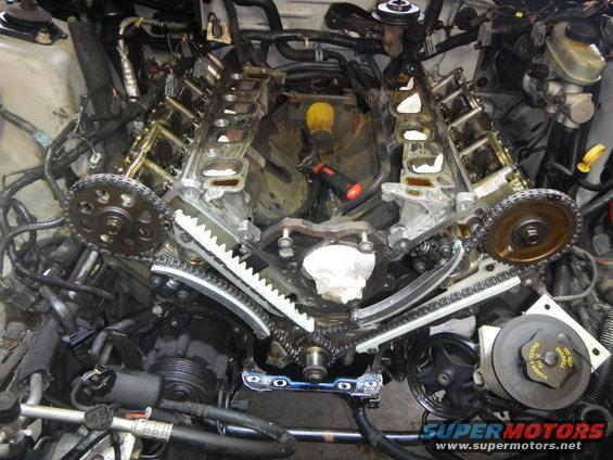 engine with timing chains and gears exposed during service