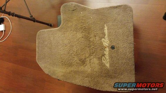 Tan carpet floor mat with embroidered Eddie Bauer script logo