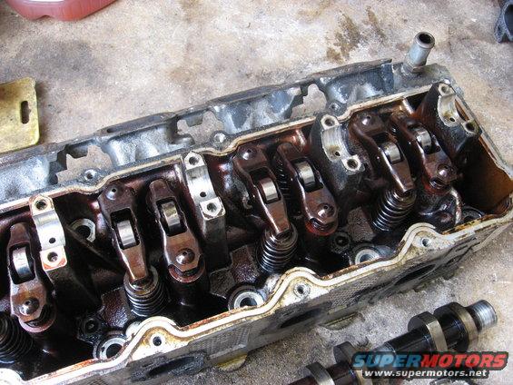 Engine cylinder head with rocker arms and springs, Supermotors.net logo visible