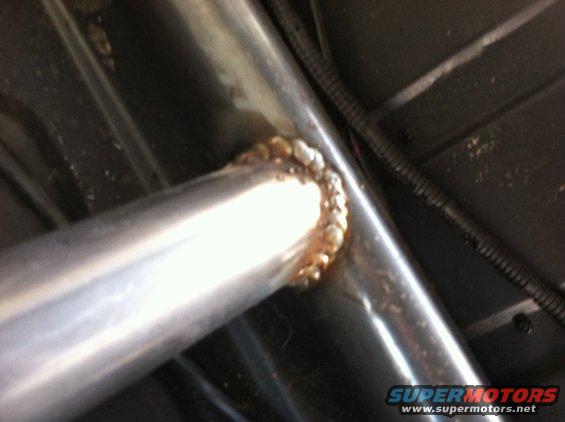 Welded roll cage tubing with Supermotors.net watermark