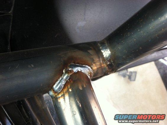 Welded metal pipes with visible weld marks and discoloration